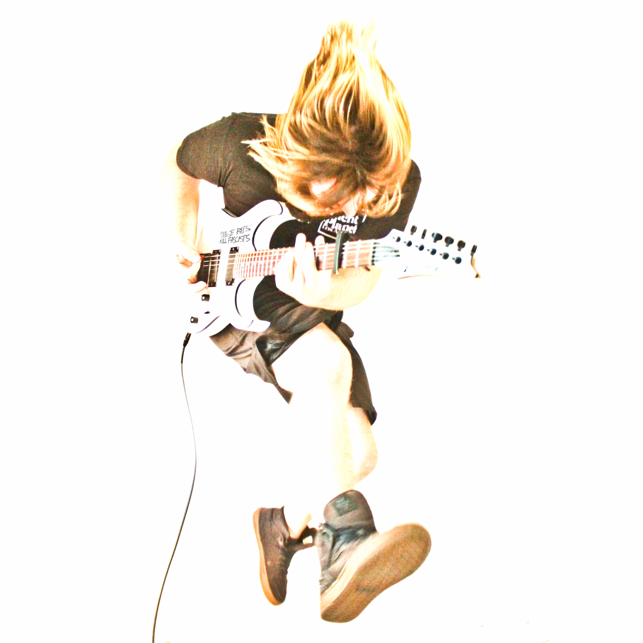A photo of MAGStock Performer Plasma Cutter is displayed. The image features the solo artist amidst a powerful display of shredding their guitar, capturing a still of a jumpkick while banging their head and throwing their arm down the strings. The image is enhanced over a white background and gives a "deep fried" aesthetic.
